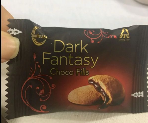 Original phone photo of a chocolate biscuit wrapper held in hand